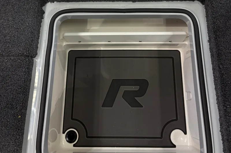 Slide: The Image of A storage compartment with an "R" logo inside a Ranger Z519R boat. - 16