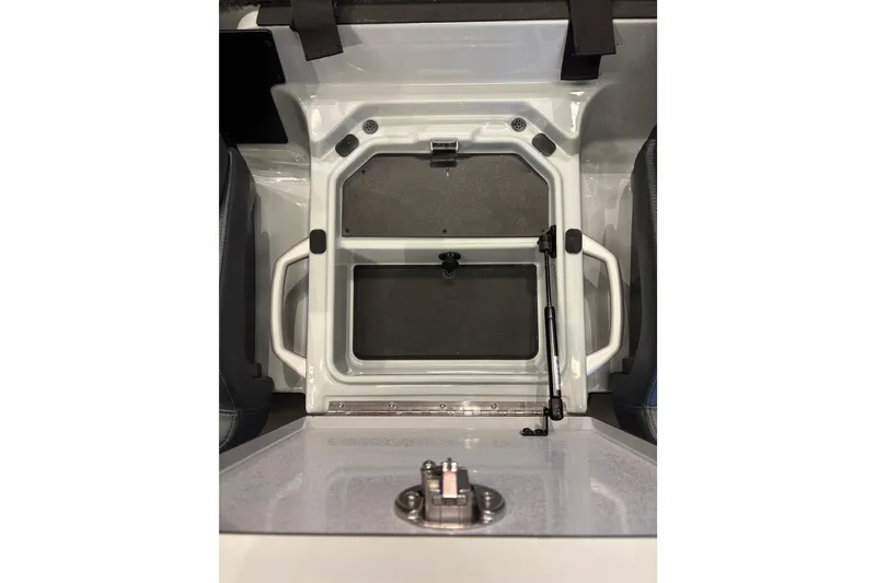 Slide: The Image of An open storage compartment on a 2026 Ranger Z519R boat, featuring handles and a latch. - 14