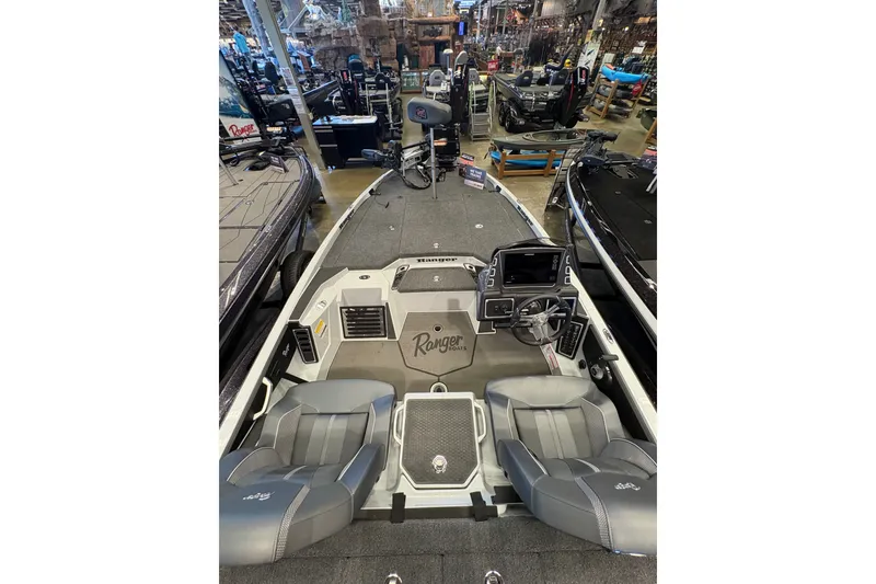 Slide: The Image of 2026 Ranger Z519R boat interior with dual seats and advanced dashboard in showroom. - 7