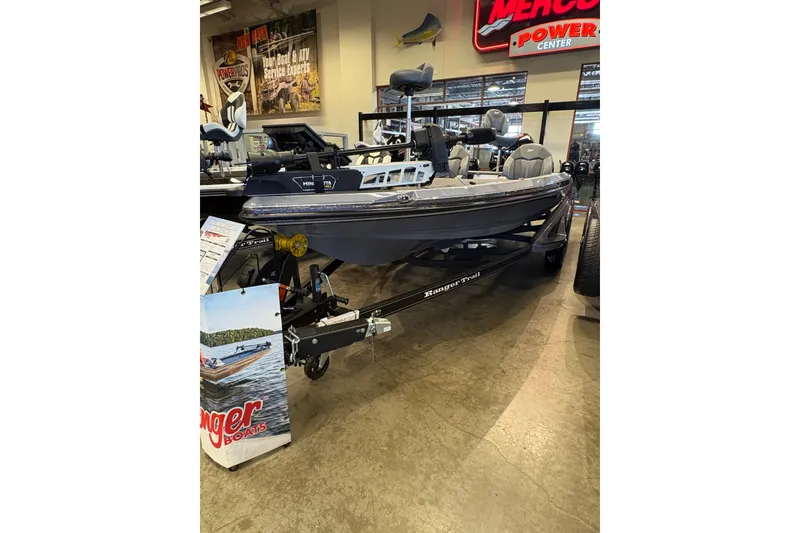 The Image of 2026 Ranger Z519R boat displayed indoors at a showroom with promotional signage. - 0