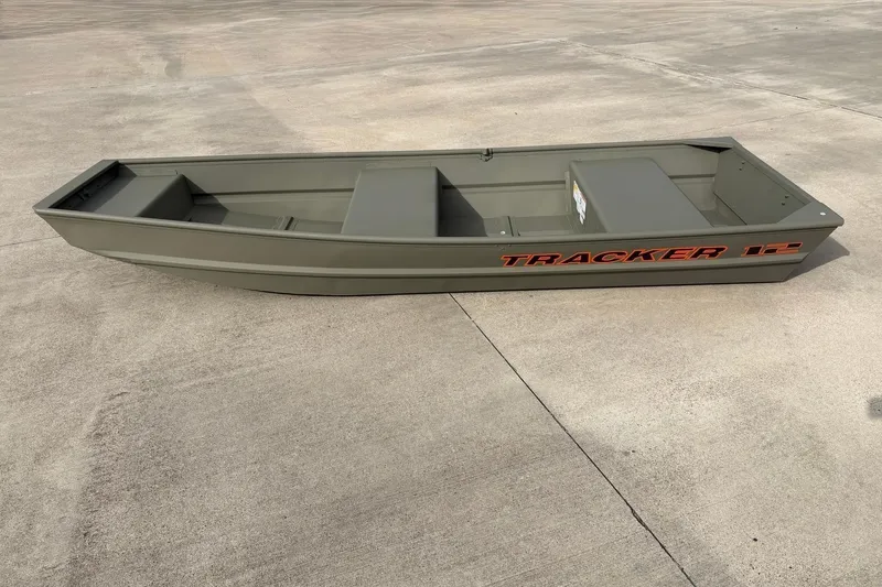 The Image of 2026 Tracker Grizzly 12 Jon boat on concrete surface, showcasing its sleek design. - 0