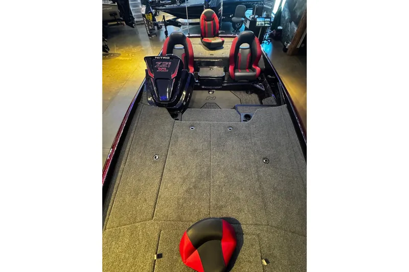 Slide: The Image of 2026 Nitro Z21 XL Pro boat interior with red and black seating, spacious deck. - 5