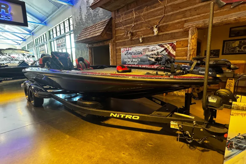 Slide: The Image of 2026 Nitro Z21 XL Pro boat displayed indoors with rustic decor and promotional signage. - 3