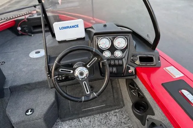 Slide: The Image of 2026 Tracker Targa V-18 WT boat dashboard with steering wheel and navigation system. - 113