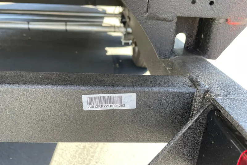 Slide: The Image of Close-up of a 2026 Sun Tracker Party Barge 22 RF XP3 with visible serial number. - 103