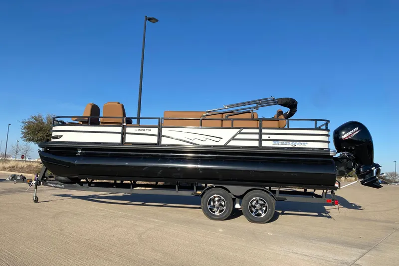 The Image of 2026 Ranger 220FC pontoon boat on trailer, featuring sleek design and Mercury outboard motor. - 1