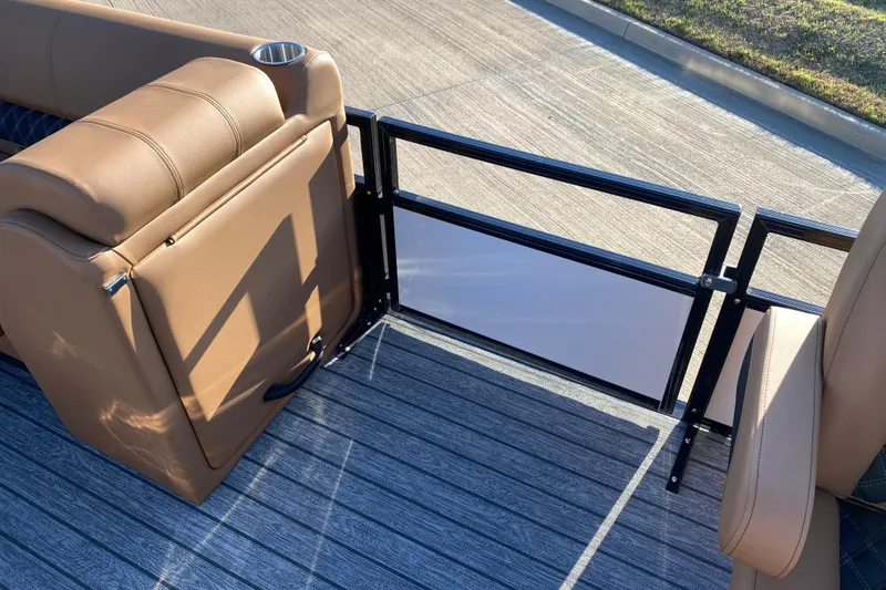 Slide: The Image of 2026 Ranger 220FC boat interior with tan seating and metal railing. - 11