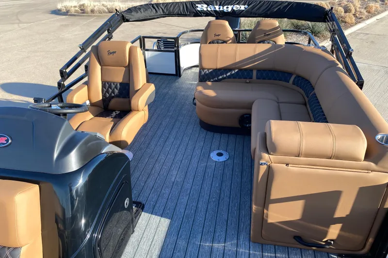 Slide: The Image of 2026 Ranger 220FC boat interior with tan seating and sleek design. - 12