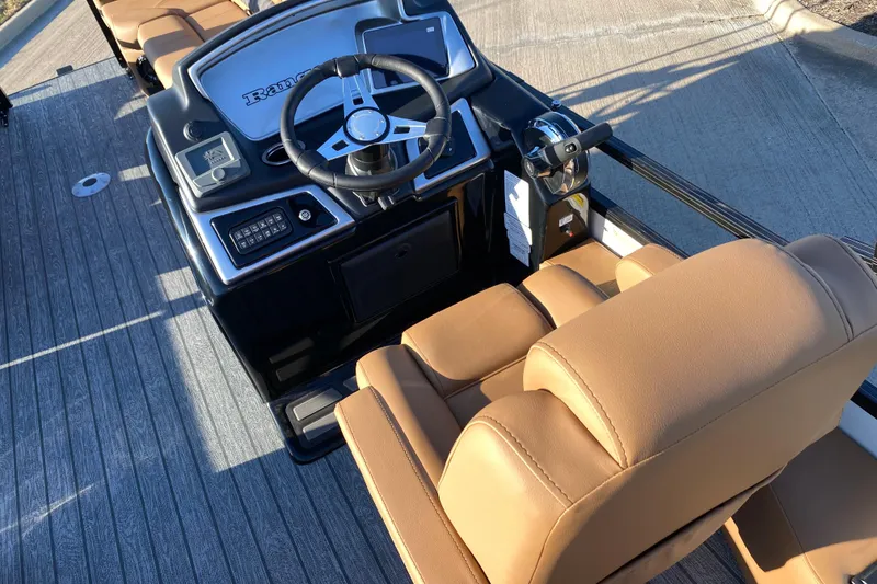 Slide: The Image of 2026 Ranger 220FC boat interior with steering wheel and tan seating. - 14