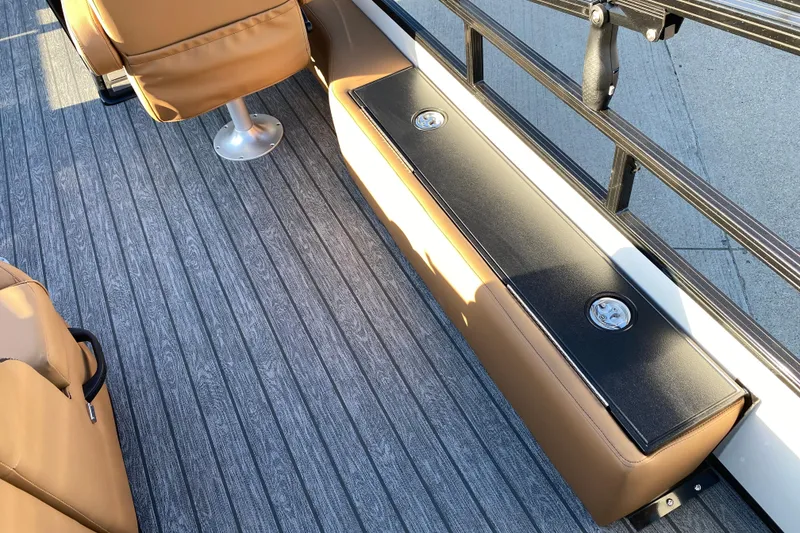 Slide: The Image of 2026 Ranger 220FC boat interior with tan seating and gray flooring. - 15