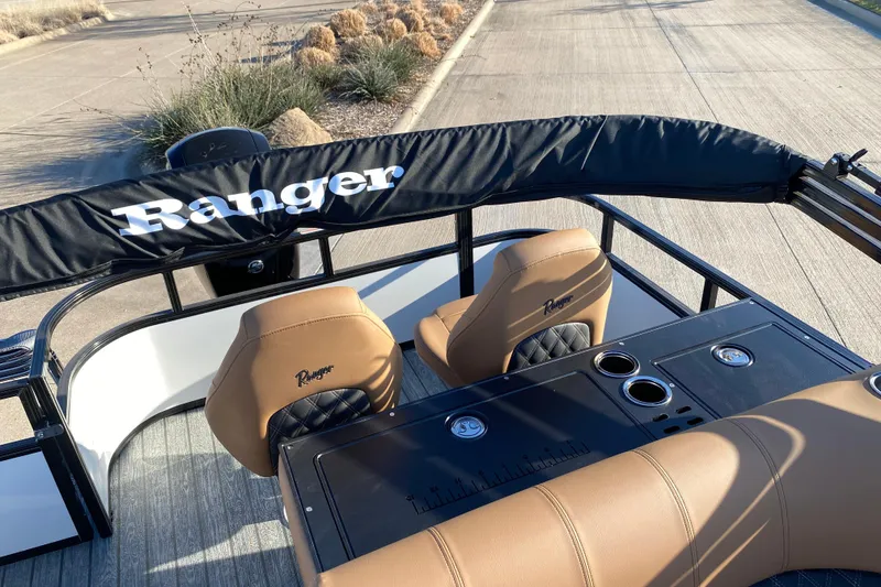 Slide: The Image of 2026 Ranger 220FC boat interior with tan seats and black accents. - 16