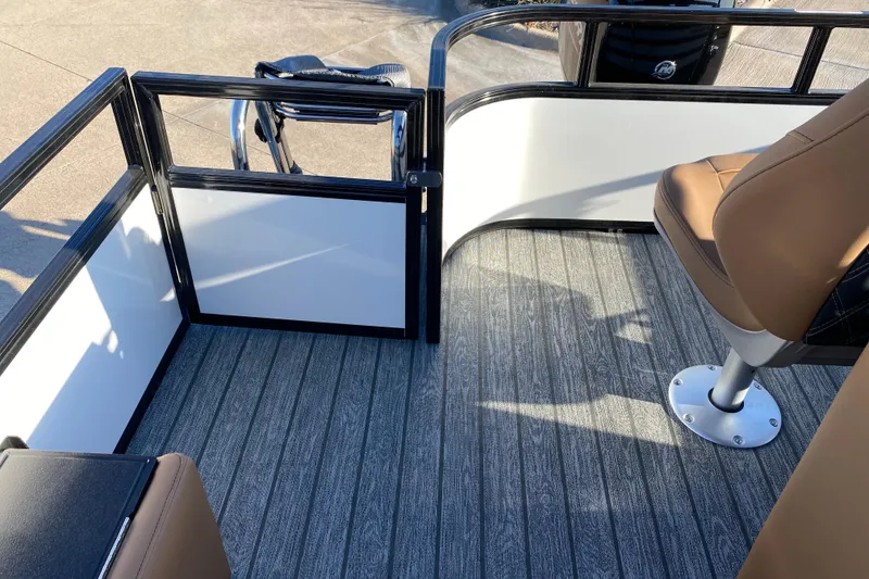 Slide: The Image of 2026 Ranger 220FC boat interior with brown seating and sleek flooring design. - 18