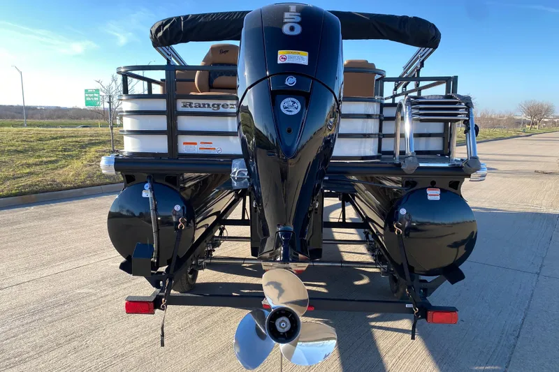 Slide: The Image of 2026 Ranger 220FC boat with powerful outboard motor on a sunny day. - 19