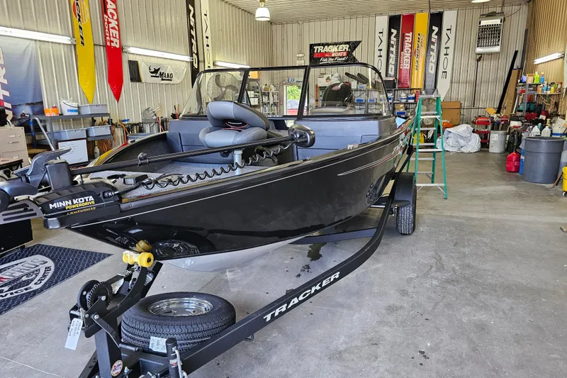 Slide: The Image of 2026 Tracker Pro Guide V-175 Combo boat in a workshop, featuring Minn Kota PowerDrive motor. - 62