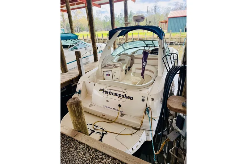 The Image of 2002 Sea Ray Sundancer 320 docked in a marina, rear view. - 0