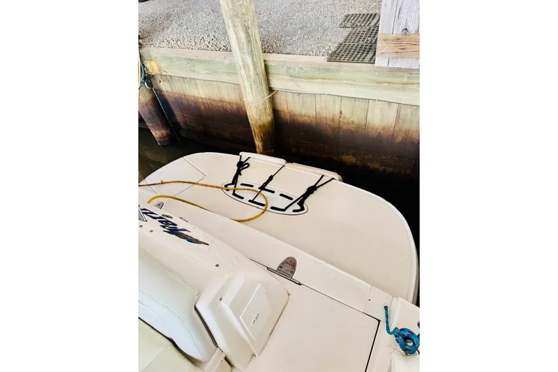 Slide: The Image of 2002 Sea Ray Sundancer 320 docked, showing rear deck and mooring lines. - 11