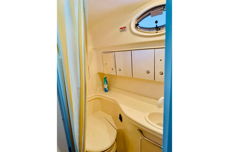Slide: The Image of 2002 Sea Ray Sundancer 320 bathroom with compact design and storage cabinets. - 15
