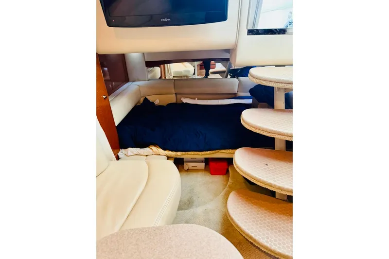 Slide: The Image of Interior of 2002 Sea Ray Sundancer 320 with cozy sleeping area and curved steps. - 18
