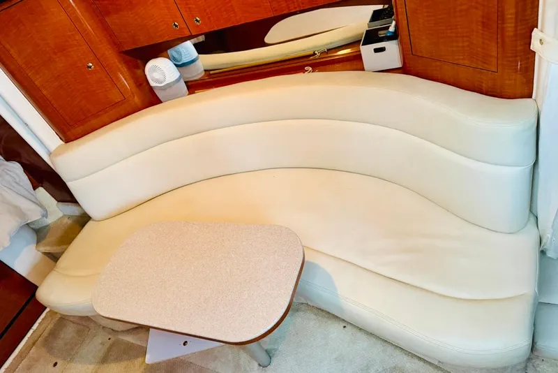 Slide: The Image of Interior of 2002 Sea Ray Sundancer 320 with curved seating and wooden cabinetry. - 19