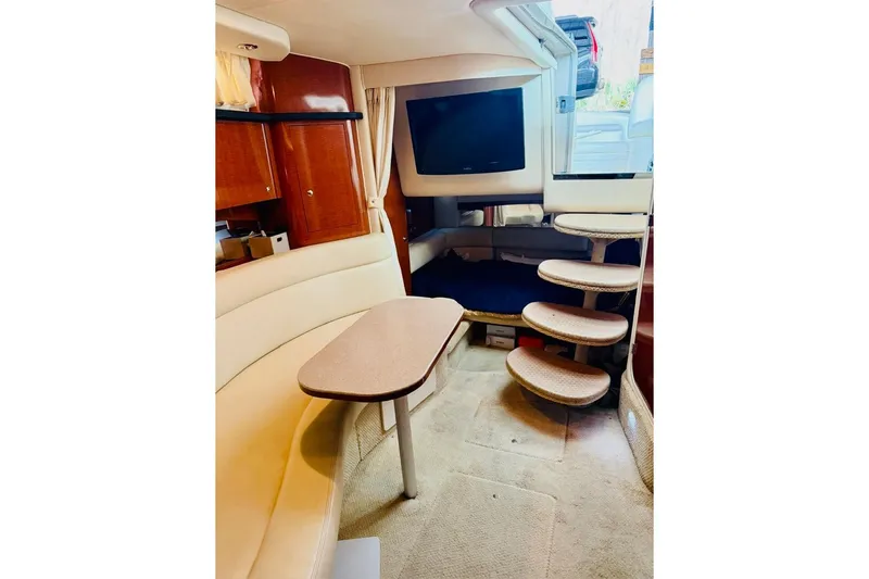 Slide: The Image of Interior of 2002 Sea Ray Sundancer 320 with cozy seating and elegant wooden cabinetry. - 21