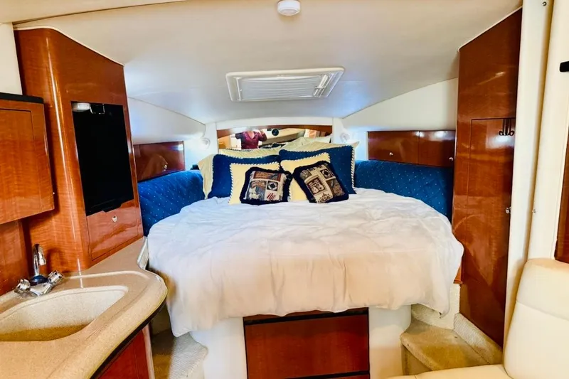 Slide: The Image of Luxurious cabin interior of 2002 Sea Ray Sundancer 320 yacht with cozy bedding. - 22