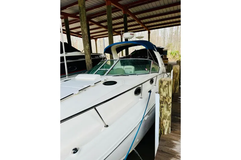 Slide: The Image of 2002 Sea Ray Sundancer 320 docked under a covered marina. - 3