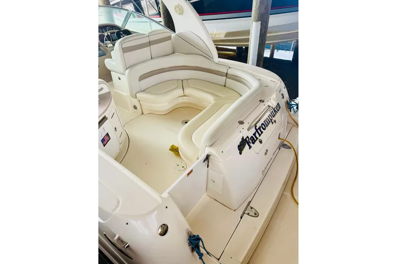 Slide: The Image of 2002 Sea Ray Sundancer 320 boat interior with white seating and dashboard. - 5