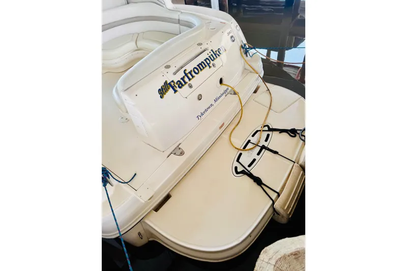 Slide: The Image of 2002 Sea Ray Sundancer 320 boat docked, featuring rear deck and seating area. - 6