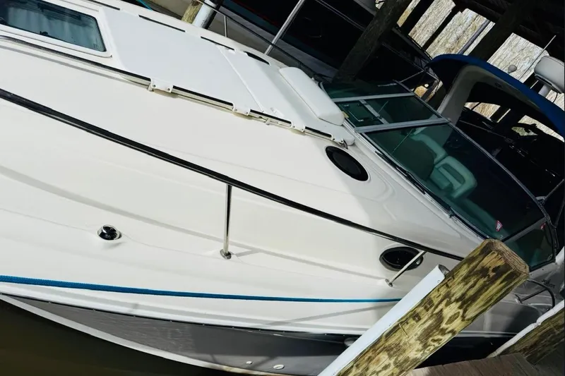 Slide: The Image of 2002 Sea Ray Sundancer 320 docked, showcasing sleek design and white exterior. - 7