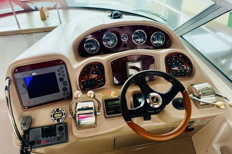 Slide: The Image of Steering console of a 2002 Sea Ray Sundancer 320 with gauges and navigation equipment. - 9