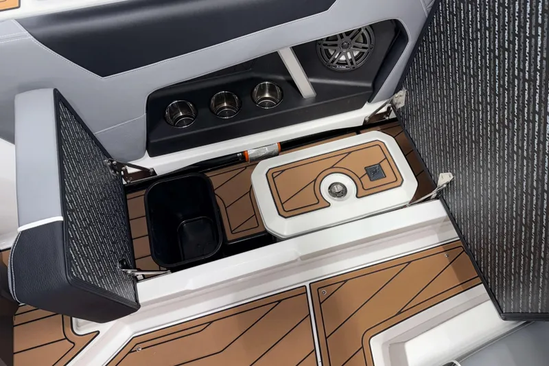 Slide: The Image of 2026 Nautique Super Air Nautique GS20 interior with storage compartments and cup holders. - 13