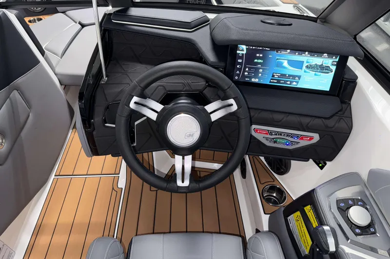 Slide: The Image of 2026 Nautique Super Air Nautique GS20 dashboard with touchscreen and steering wheel. - 17