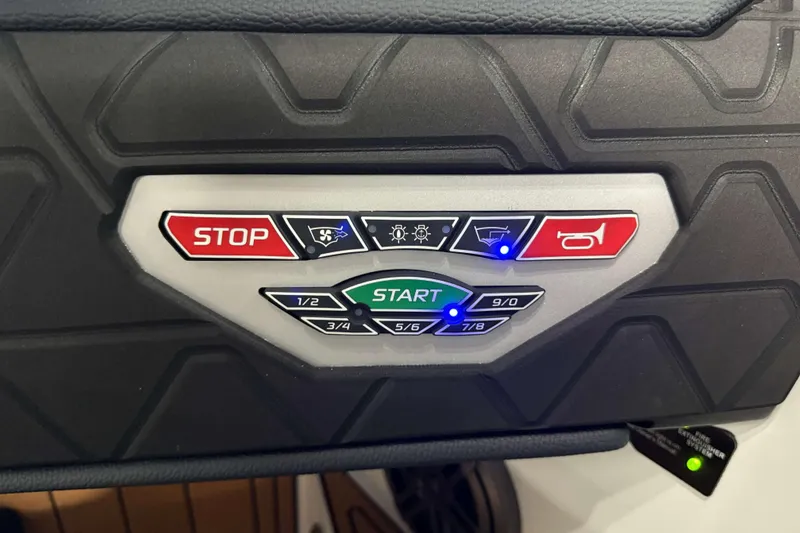 Slide: The Image of Control panel of 2026 Nautique Super Air Nautique GS20 with start and stop buttons. - 20