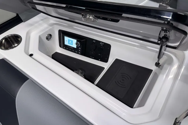 Slide: The Image of 2026 Nautique Super Air Nautique GS20 dashboard with JL Audio system and wireless charging pad. - 24