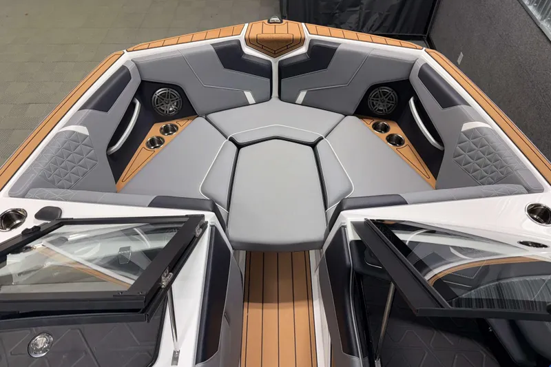 Slide: The Image of 2026 Nautique Super Air Nautique GS20 boat interior with gray seating and cup holders. - 26