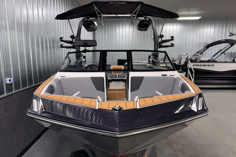 Slide: The Image of 2026 Nautique Super Air Nautique GS20 boat in showroom, sleek design with modern features. - 34