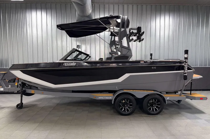 Slide: The Image of 2026 Nautique Super Air Nautique GS20 boat on trailer in showroom. - 35