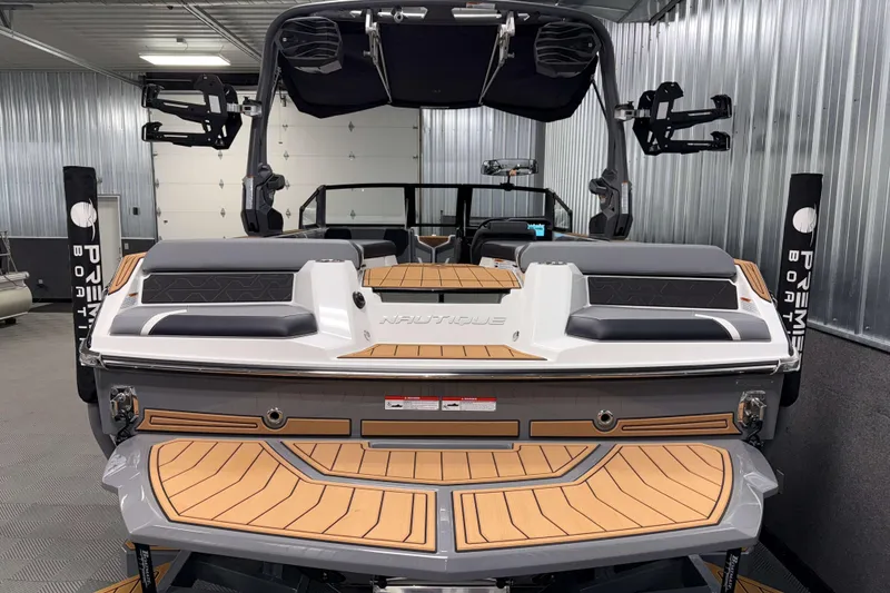 Slide: The Image of 2026 Nautique Super Air Nautique GS20 boat in a showroom, rear view. - 37