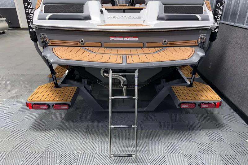 Slide: The Image of 2026 Nautique Super Air Nautique GS20 boat rear view with swim platform and ladder. - 38