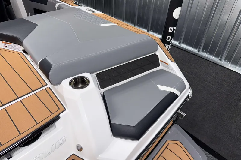 Slide: The Image of 2026 Nautique Super Air Nautique GS20 boat interior with sleek seating and cup holder. - 5