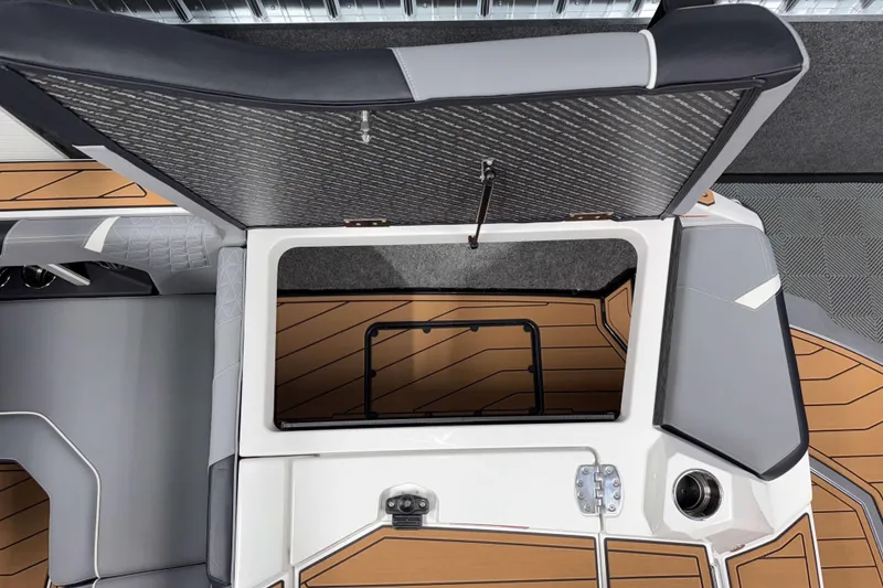 Slide: The Image of 2026 Nautique Super Air Nautique GS20 boat storage compartment with open hatch and sleek interior design. - 6