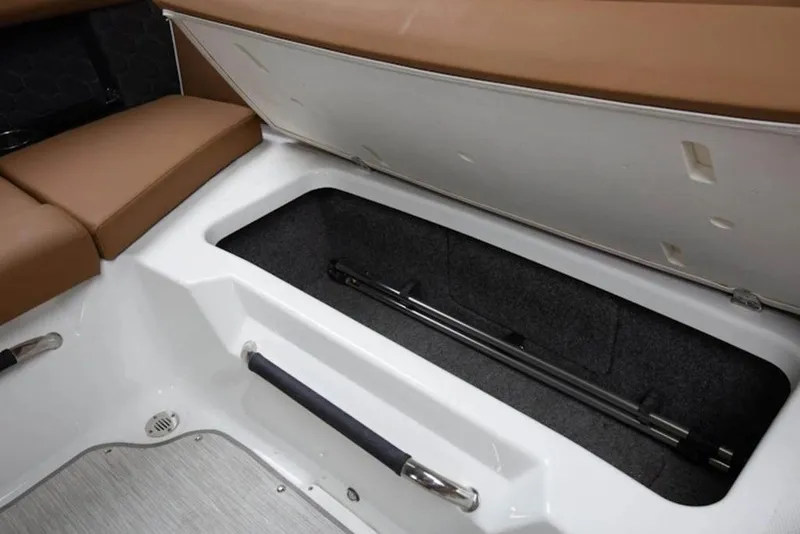 Slide: The Image of 2026 Four Winns H4 boat storage compartment with brown seating and sleek design. - 10