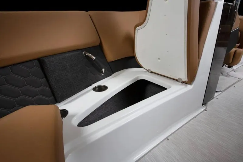 Slide: The Image of 2026 Four Winns H4 boat interior with open storage compartment and cup holders. - 11