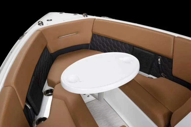 Slide: The Image of 2026 Four Winns H4 boat interior with brown seating and white table. - 8
