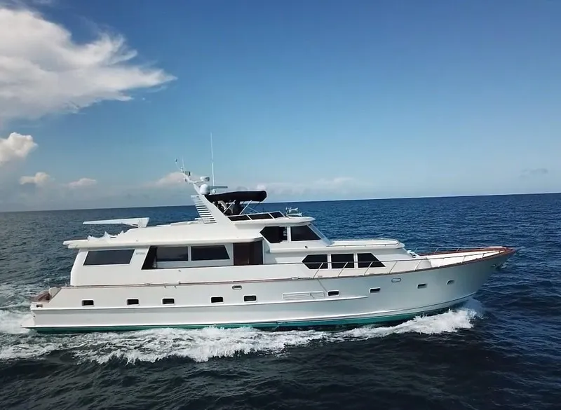 The Image of 1984 Broward CPMY luxury yacht cruising on open sea. - 0
