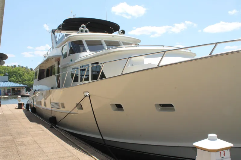 Slide: The Image of 1984 Broward CPMY yacht docked under sunny skies. - 10