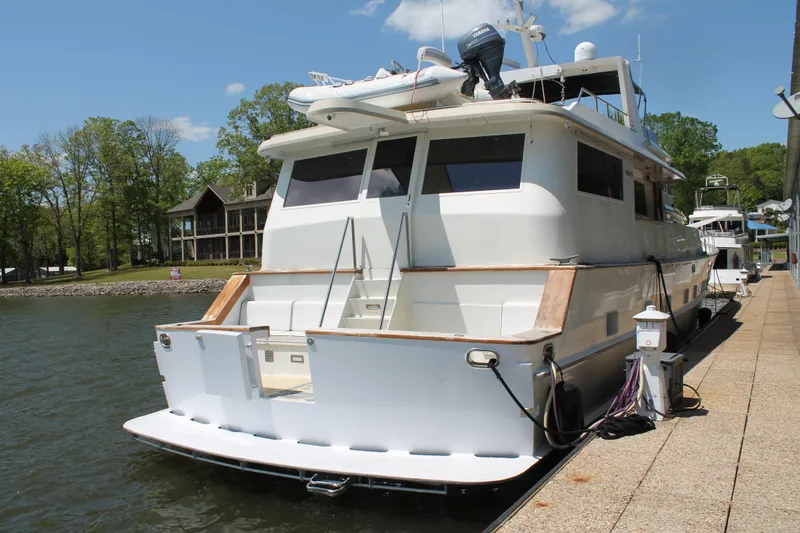 Slide: The Image of 1984 Broward CPMY yacht docked on a sunny day. - 12
