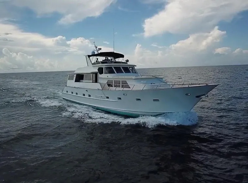 Slide: The Image of 1984 Broward CPMY yacht cruising on open sea. - 2