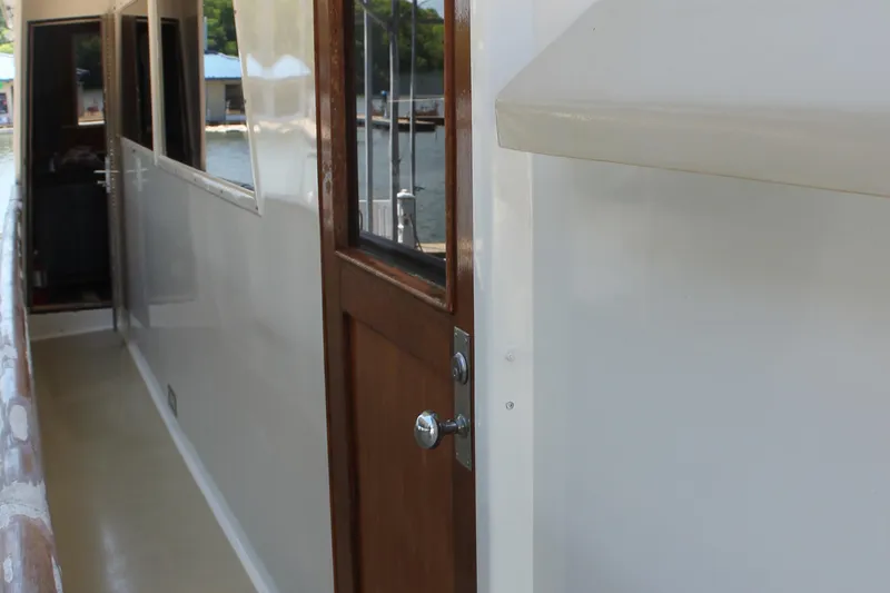 Slide: The Image of Side deck of 1984 Broward CPMY with wooden door. - 25