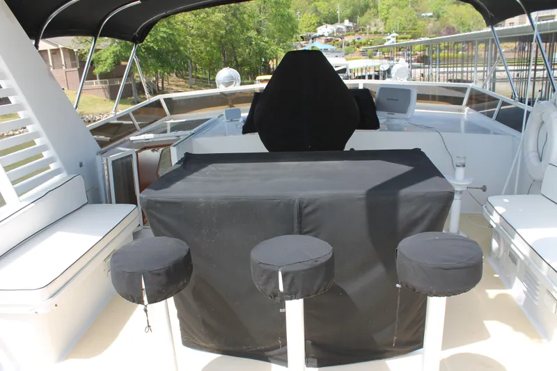 Slide: The Image of 1984 Broward CPMY yacht with raised pilothouse, outdoor seating area. - 26